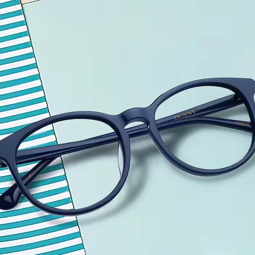 Blue round-frame glasses with "ARMANI" engraved on the temple.