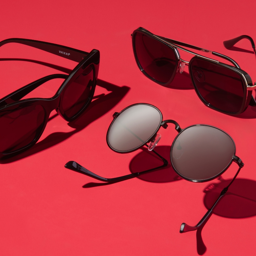 Three pairs of sunglasses on a red surface, one labeled "Karün".